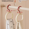 A white wall hook is shown rotating to easily hang and remove a fabric item like a scarf or hat.