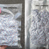 A hand holds a clear plastic bag containing 100 food grade oxygen absorbers for long-term dry food storage.