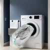 A white washing machine with a gray mesh shoe wash bag resting on its front panel.