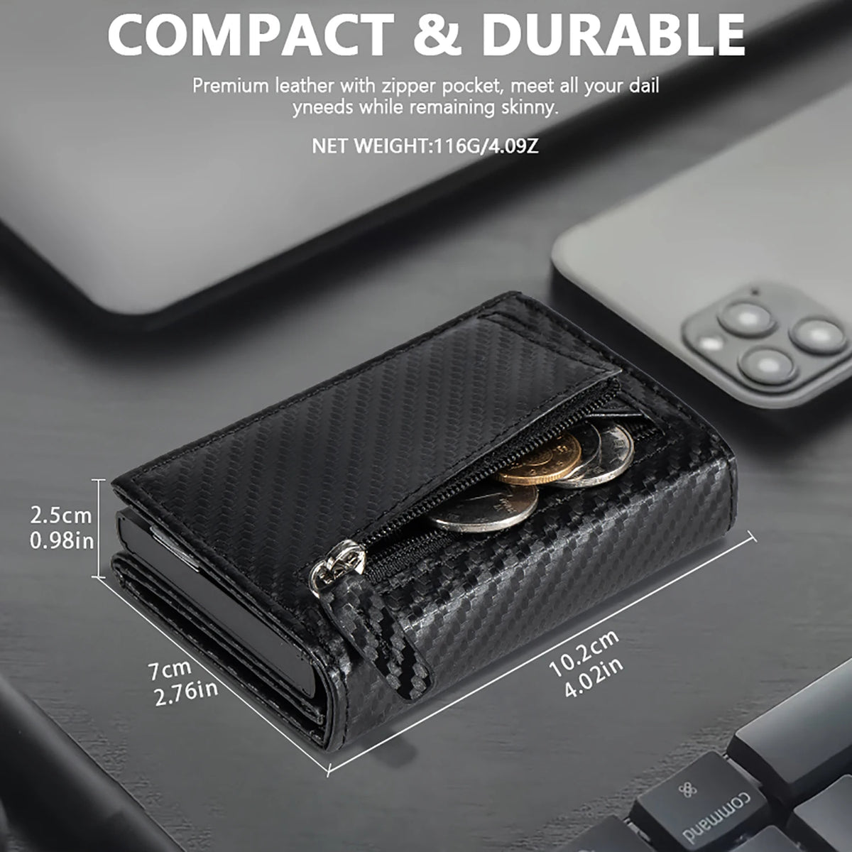 Black leather compact wallet with a zipper pocket shown next to a smartphone.
