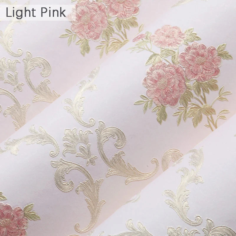 Light pink wallpaper featuring delicate gold floral embroidery and leaves.