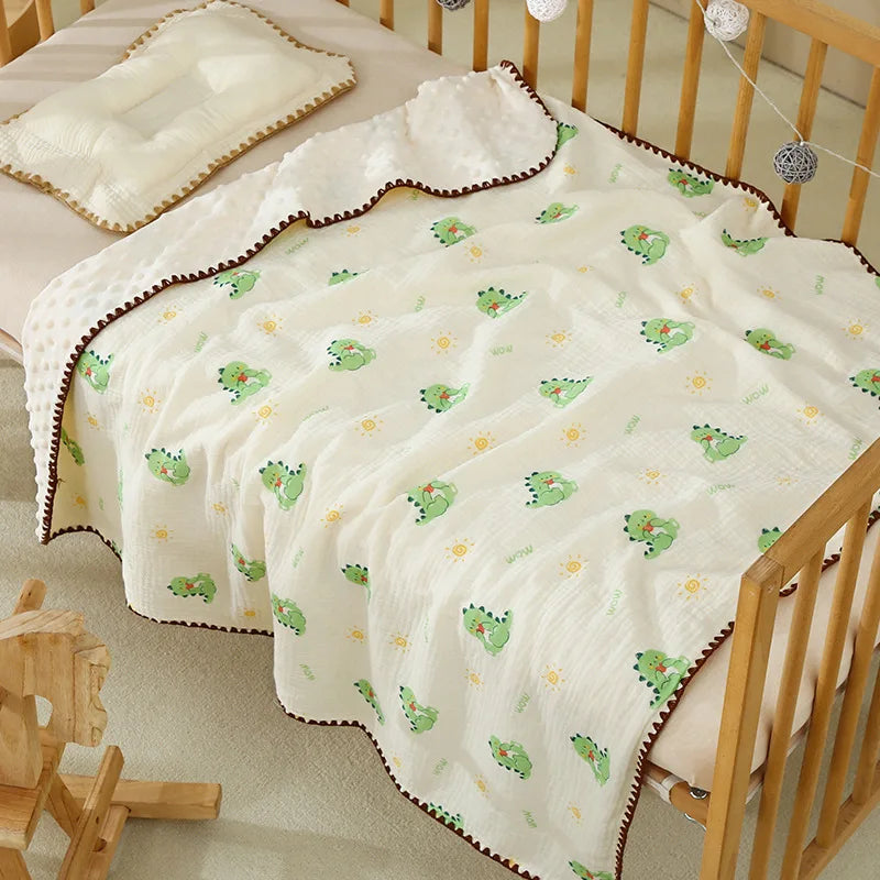 A white cotton gauze baby swaddle blanket with a bear print pattern is draped over a wooden crib.