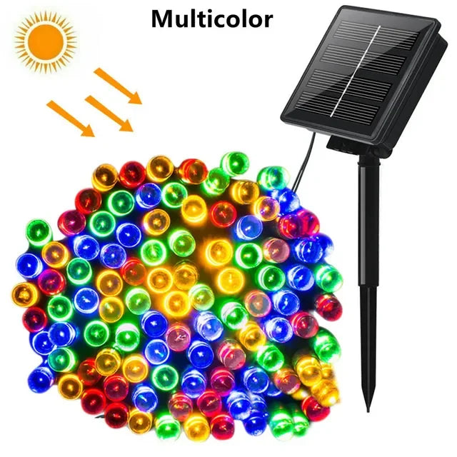 A cluster of multicolor LED string lights powered by a solar panel, ready for outdoor use.
