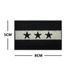 Black flag patch with three silver stars embroidered on a white stripe.