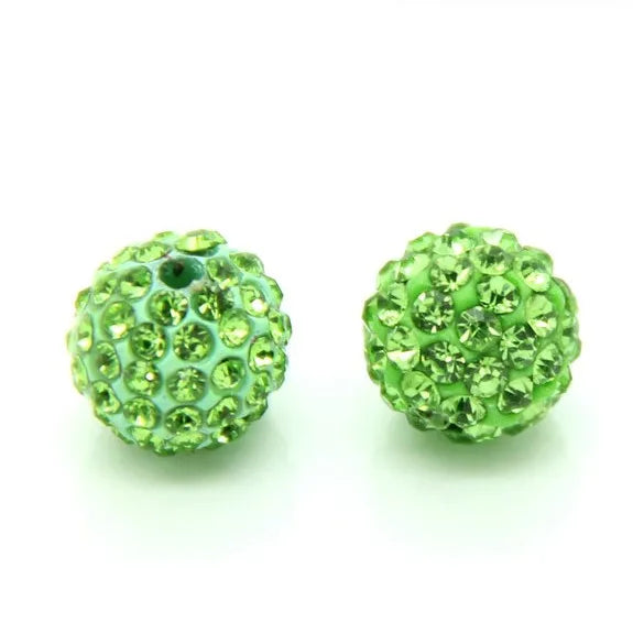 Two spherical green crystal clay beads for DIY jewelry and craft projects