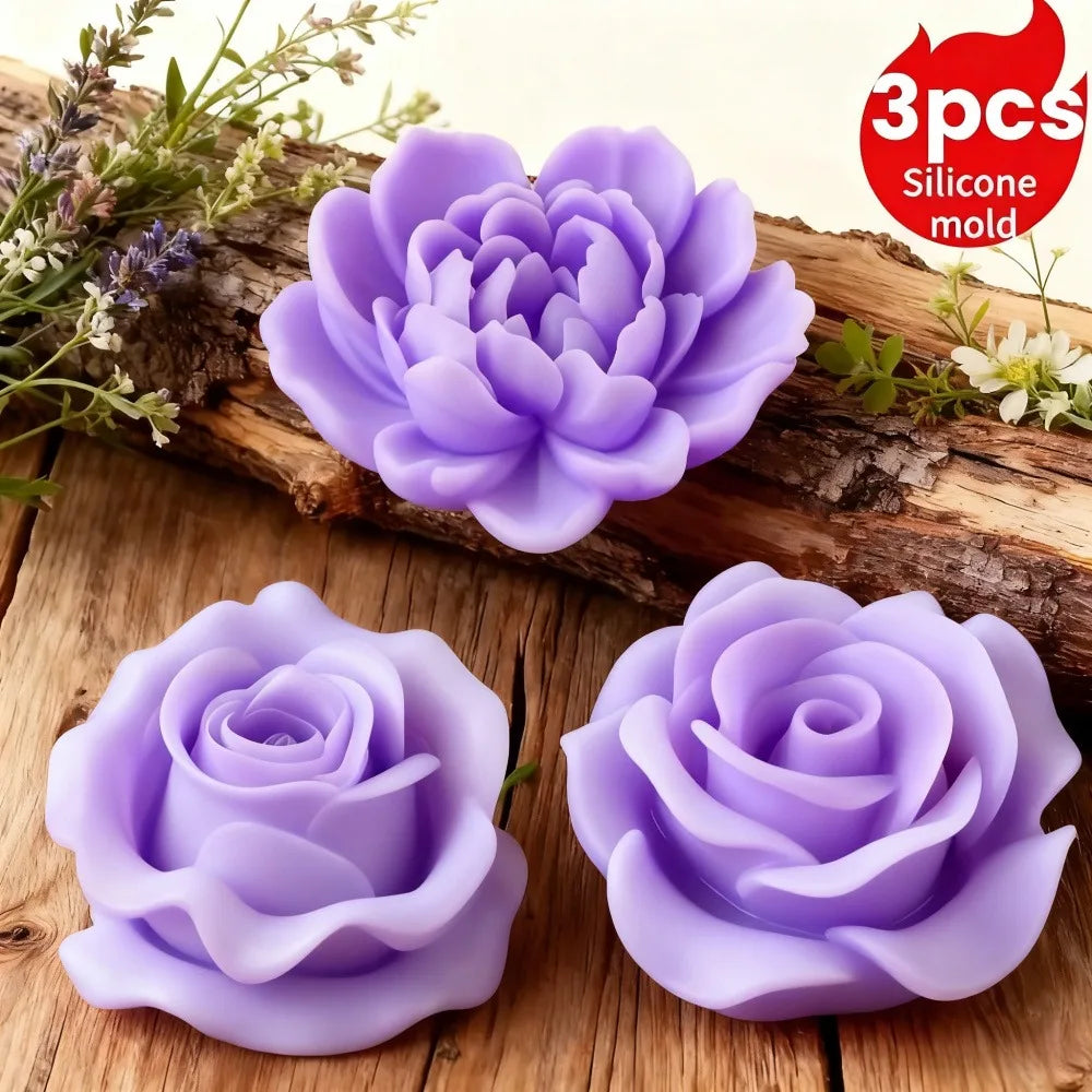 Three silicone molds shaped like purple roses and peonies resting on a wooden surface.