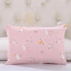 A pink cartoon pillowcase with stars and clouds is displayed on a white surface.