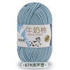 A ball of light blue milk cotton blend yarn with a label in Chinese and English.