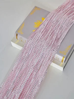 Pink glitter tassel string curtain for doorways and room dividers displayed next to its packaging.