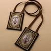 A brown leather scapular necklace featuring an immaculate heart pendant on a gold-colored chain.
