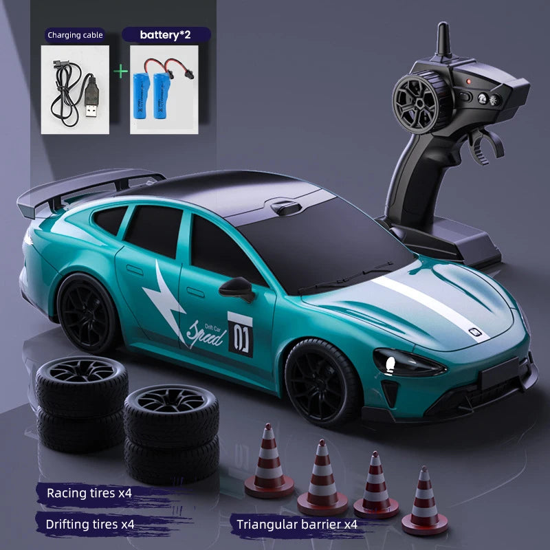A teal RC drift truck is shown with accessories like a charging cable, battery, racing tires, and triangular barriers.
