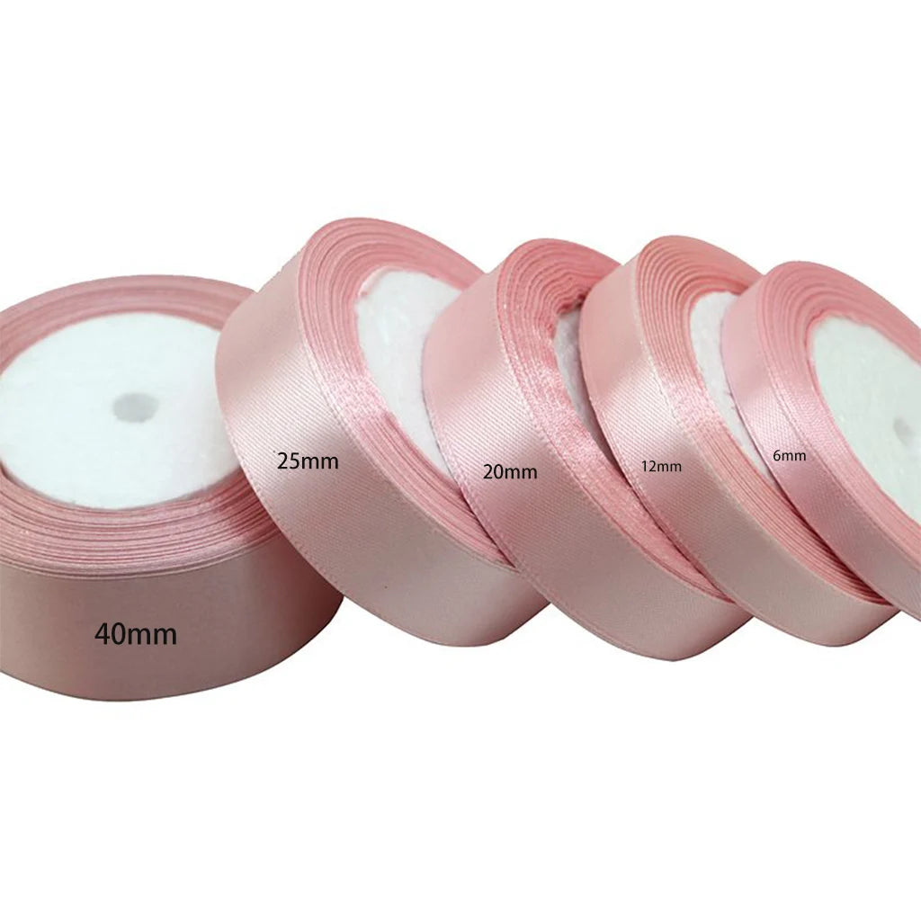 Rolls of light pink satin ribbon measuring 6mm to 40mm wide.