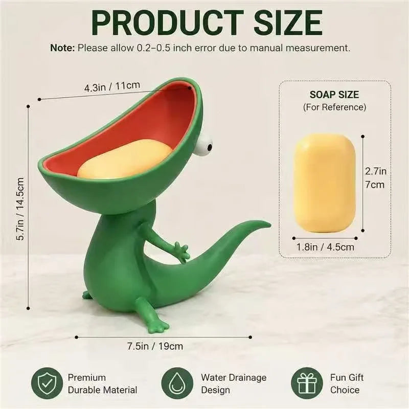 A green lizard-shaped soap holder with an open mouth design is shown next to a yellow bar of soap.