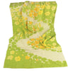 A bright lime green face towel with a yellow floral cartoon pattern.