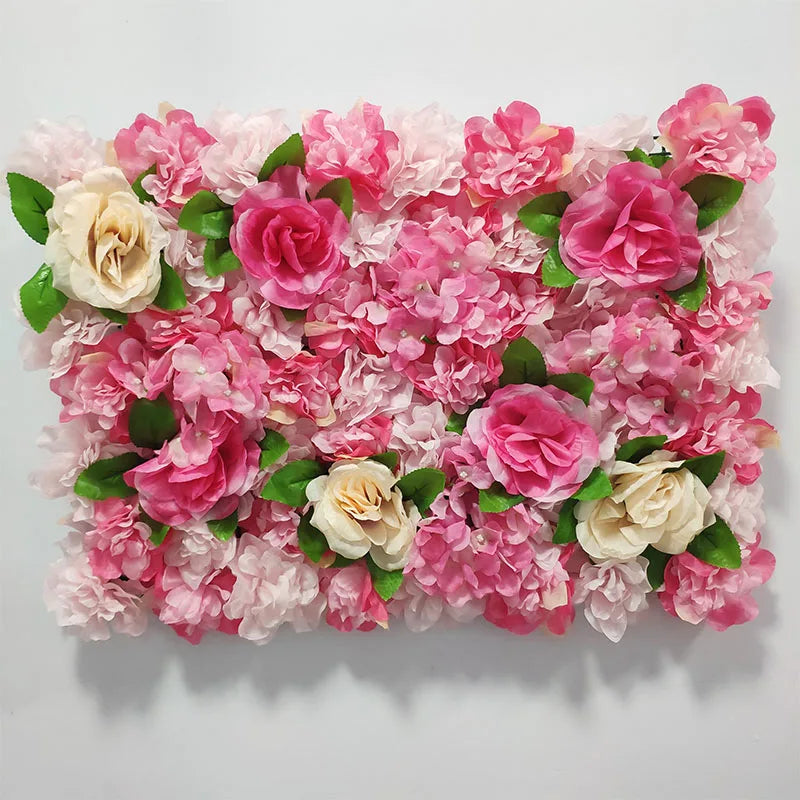 A dense wall panel of pink and cream silk rose flowers for weddings and events.
