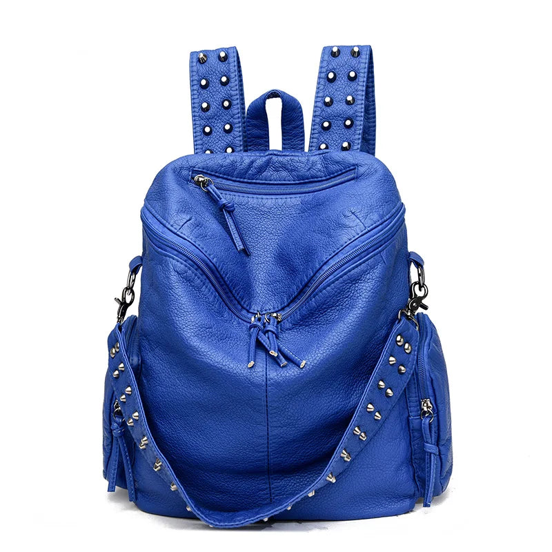 A deep blue soft leather backpack adorned with silver rivets and hardware.