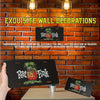 A black metal sign featuring a green rat figure and the text Rat Fink mounted on a brick wall.