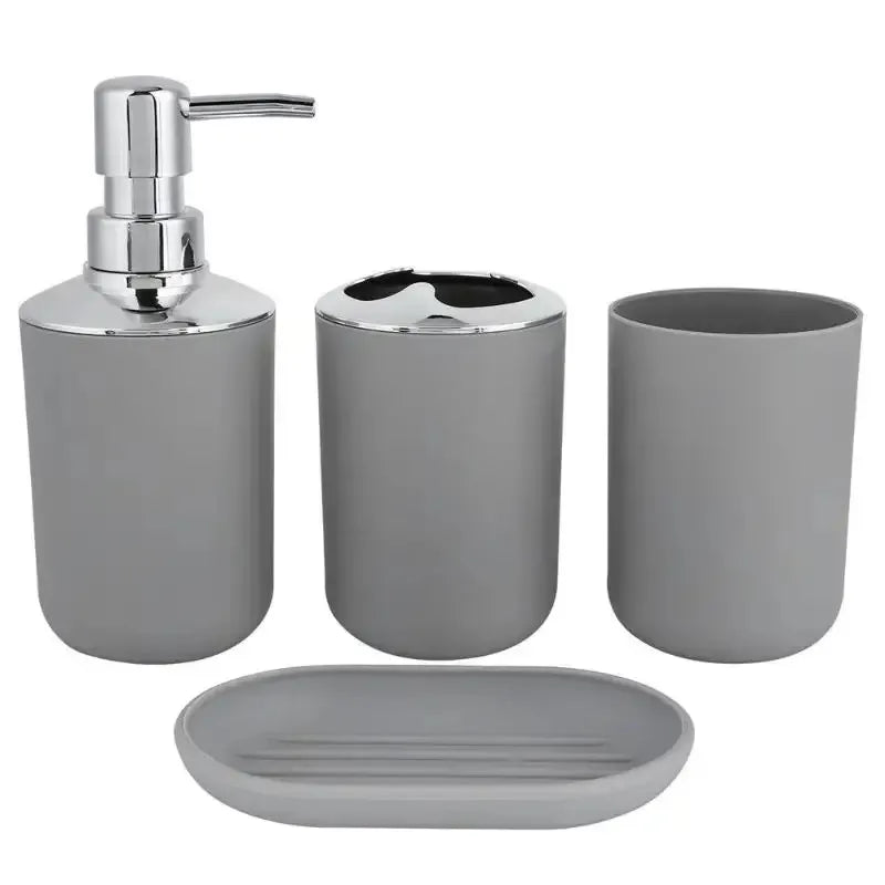 A set of four bathroom accessories including a silver soap dispenser, holder, and soap dish.