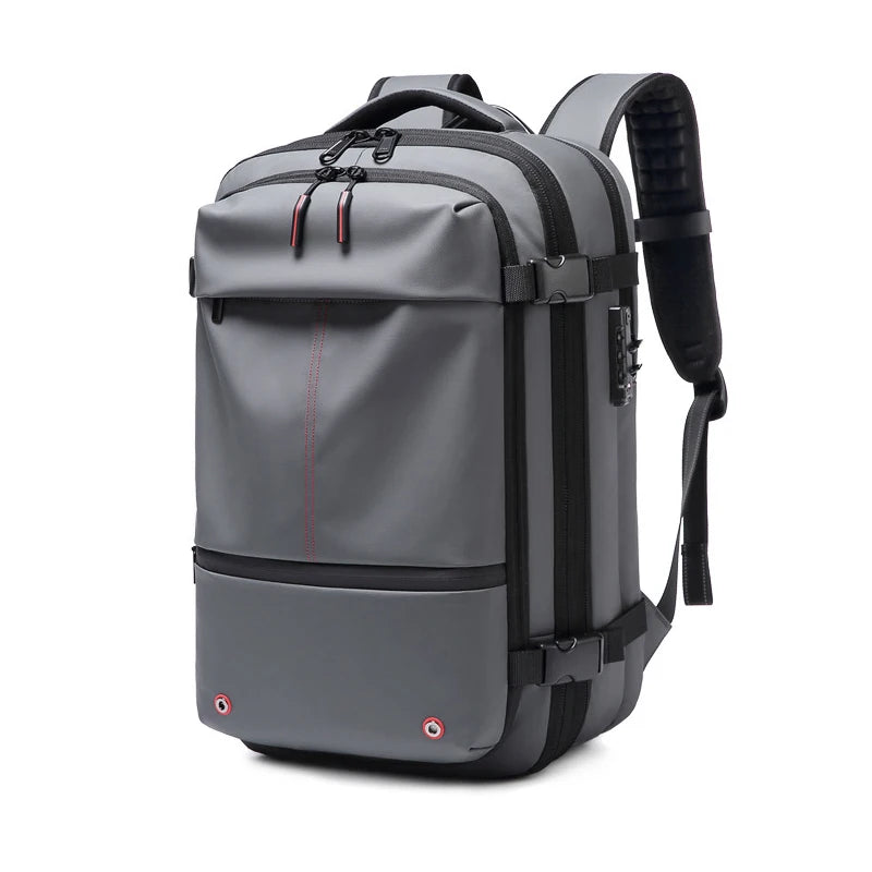 A gray expandable travel laptop backpack with black straps and compression features.