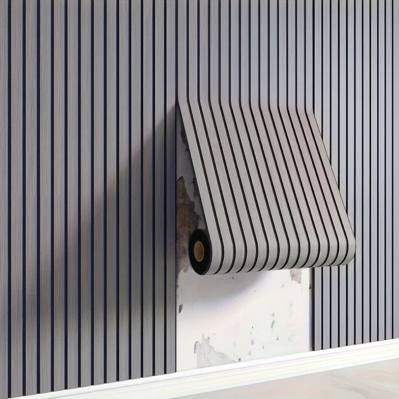 A close-up of a vertical, ribbed gray peel-and-stick wall tile installed on a light-colored wall.