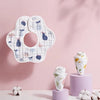 A pack of soft cotton muslin bandana bibs for babies with a floral pattern displayed on a pink background.