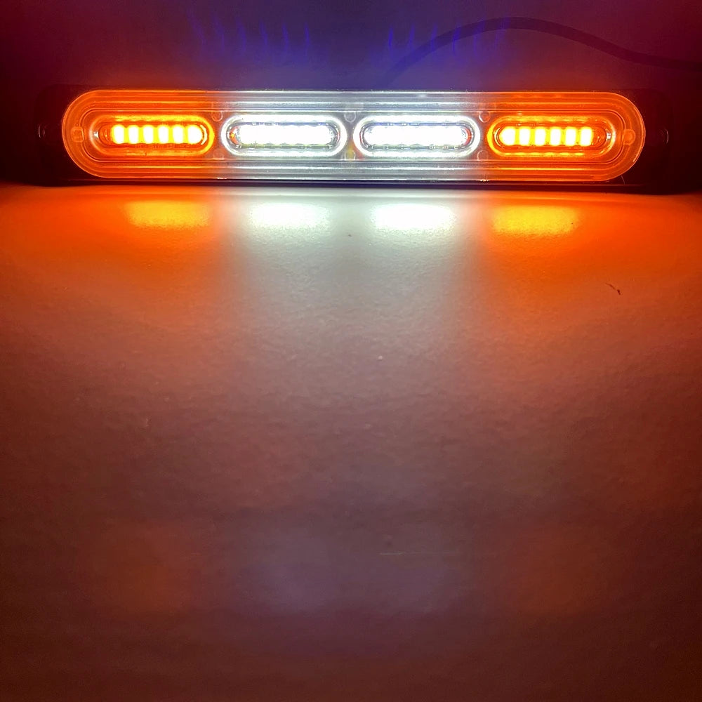 An orange LED warning light bar illuminates a surface, showing bright amber light and a focused beam.