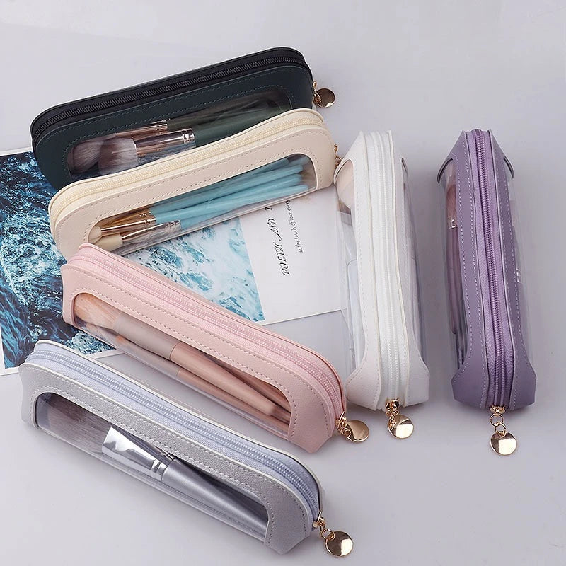 A collection of clear waterproof travel makeup organizer pouches in various pastel colors and leather trims.