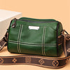 A dark green vintage genuine leather women's shoulder bag with brown leather strap and stitching.
