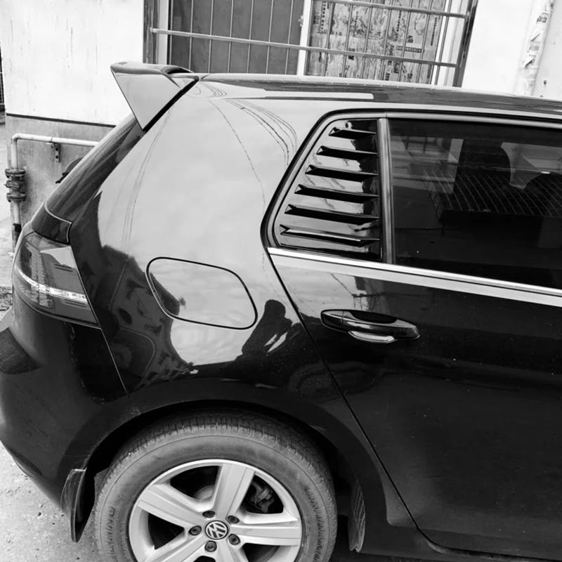 Black Volkswagen Golf rear window with louvers installed.