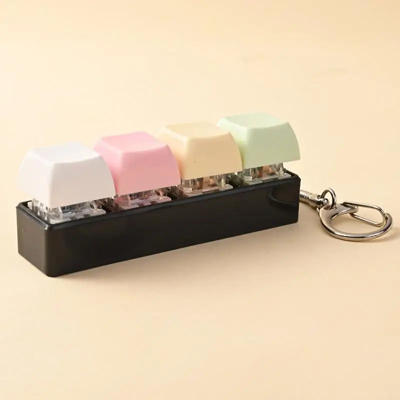 A black keychain featuring several colorful LED mechanical fidget toys with custom keycaps.
