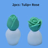 Two silicone molds shaped like tulips and roses with white bases