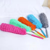 A collection of colorful electrostatic telescopic dusters with flexible stainless steel handles arranged on a white surface.