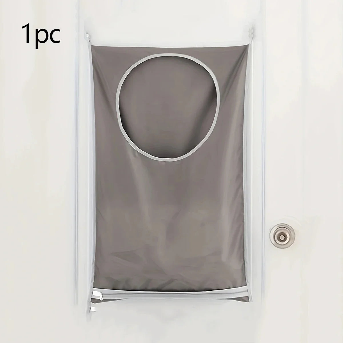 A gray wall-mounted laundry storage bag with a circular opening is displayed against a white wall.