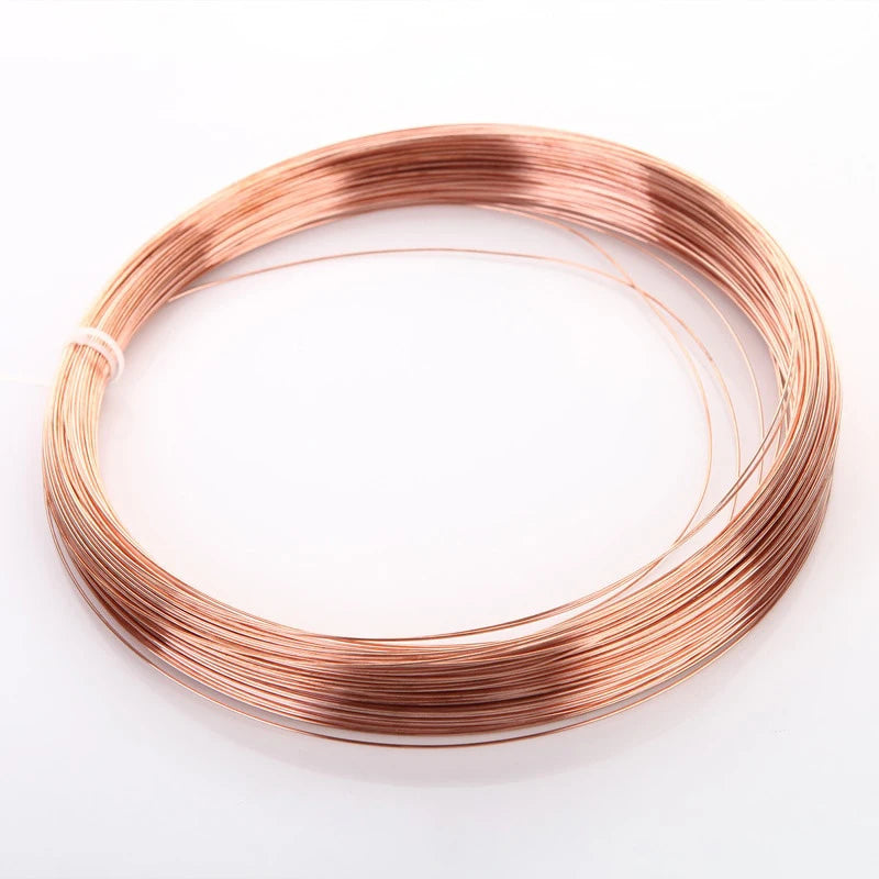 A coil of bare copper wire with multiple diameters laid out in a circle.