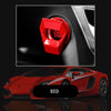 A red aluminum alloy engine start button cover is shown next to a red sports car.