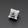 A close-up view of a white Outemu mechanical keyboard switch housing.