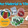 Rolls of white vinyl material, die-cut stickers, and a folded white piece of material on a wooden surface.