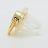 A clear silicone pacifier and clip set with a gold-colored plastic component.