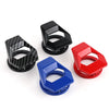 Three colored engine start button covers in black, red, and blue with carbon fiber texture.