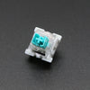 A close-up view of a white plastic 3-pin mechanical keyboard switch with a teal-colored housing.