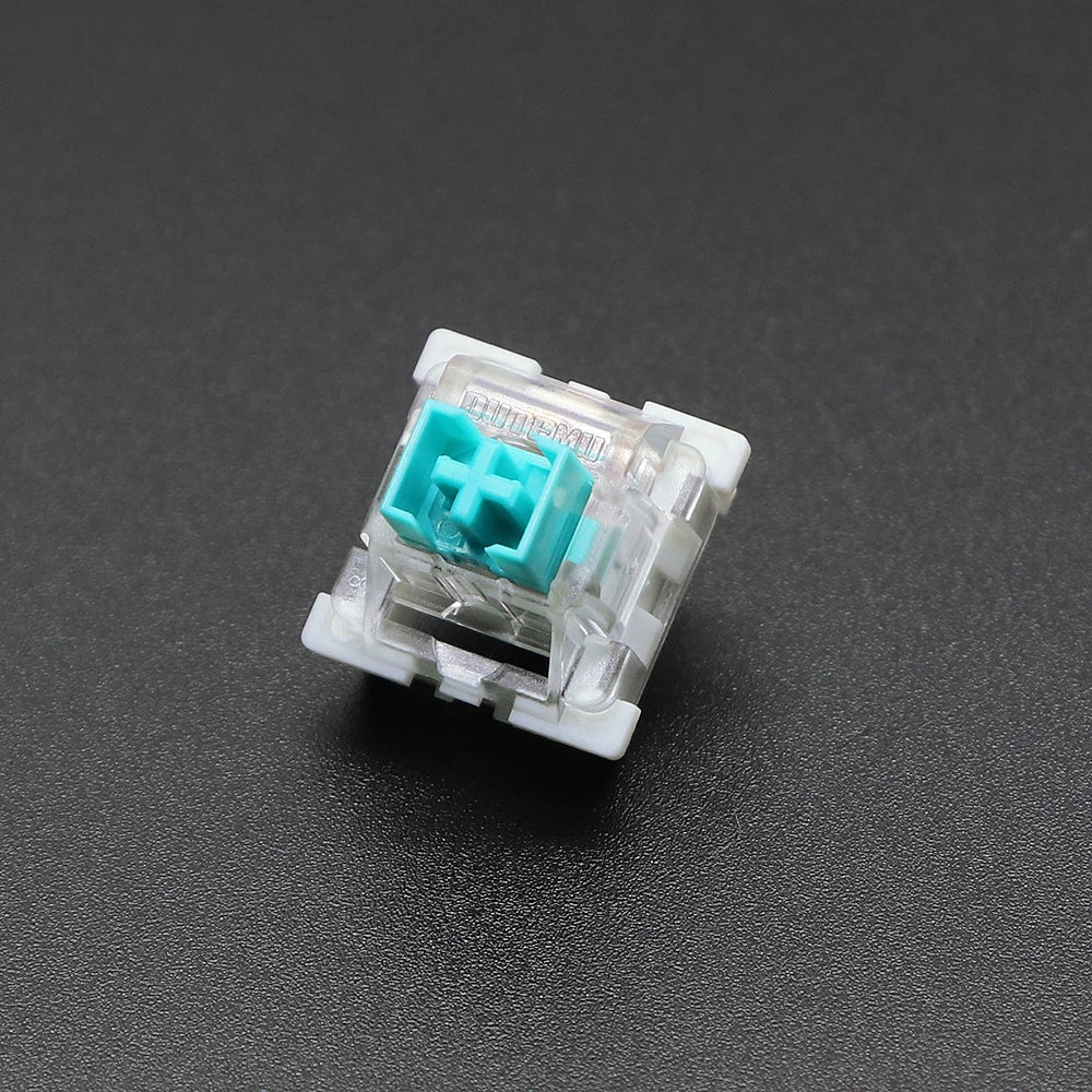 A close-up view of a white plastic 3-pin mechanical keyboard switch with a teal-colored housing.