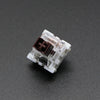 A close-up view of a white and brown outemu mechanical keyboard switch housing.
