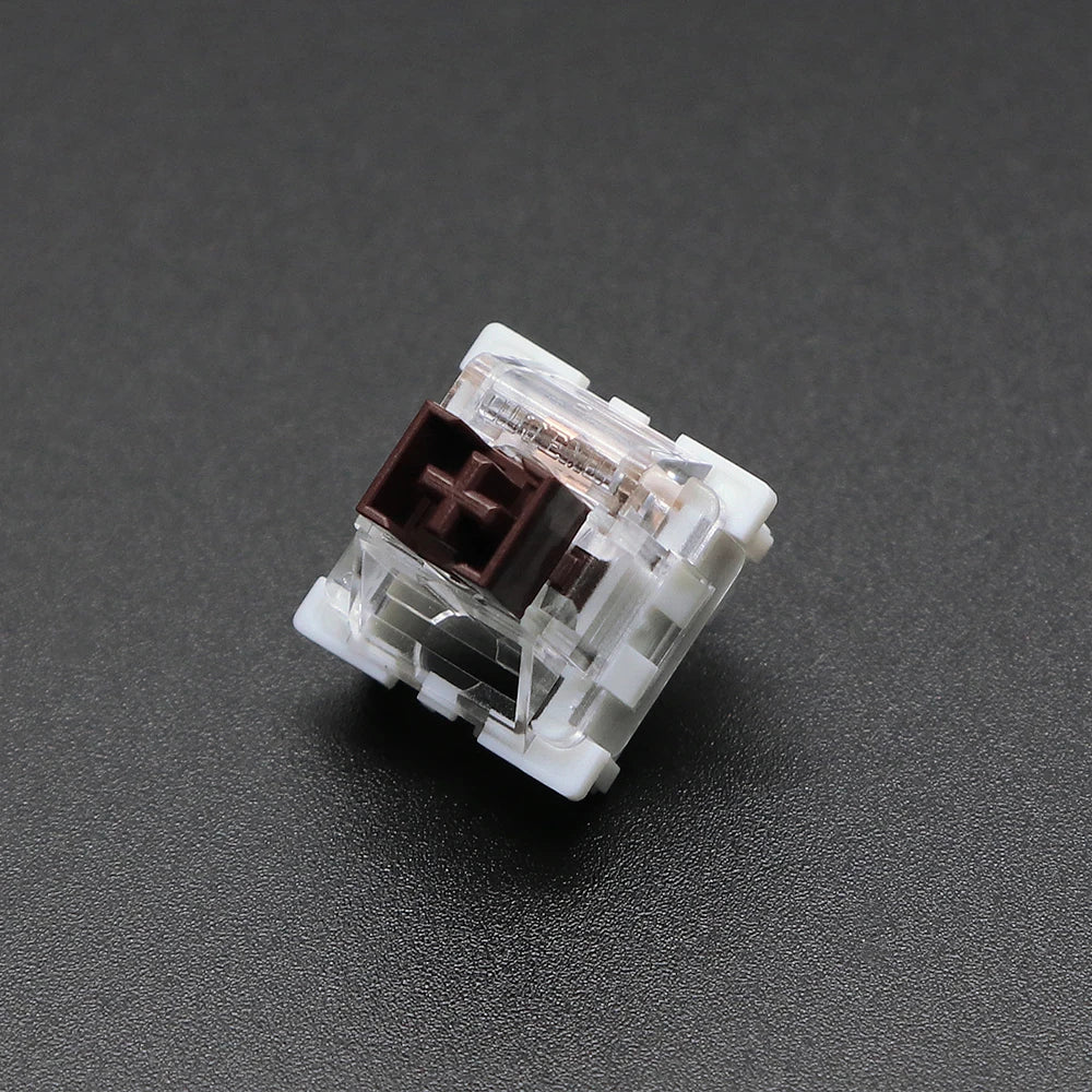 A close-up view of a white and brown outemu mechanical keyboard switch housing.