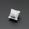 A close-up view of a white Outemu mechanical keyboard switch housing.
