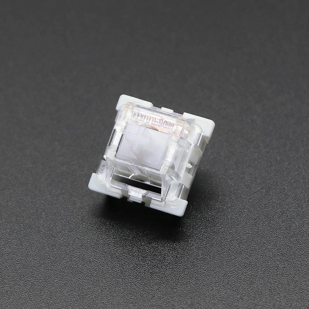 A close-up view of a white Outemu mechanical keyboard switch housing.