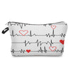 A black fabric makeup bag featuring an ECG heartbeat line print with red heart accents.