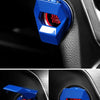 Close-up of a blue aluminum alloy engine start stop button cover on a car interior panel.