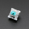 A close-up view of a white mechanical keyboard switch housing with a light blue plastic stem.