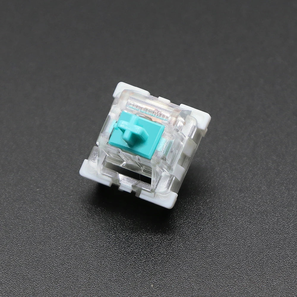 A close-up view of a white mechanical keyboard switch housing with a light blue plastic stem.