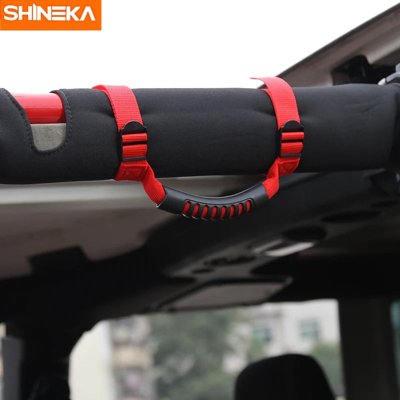 Red pull tabs on a black roll bar mount armrest for Jeep Wrangler vehicles